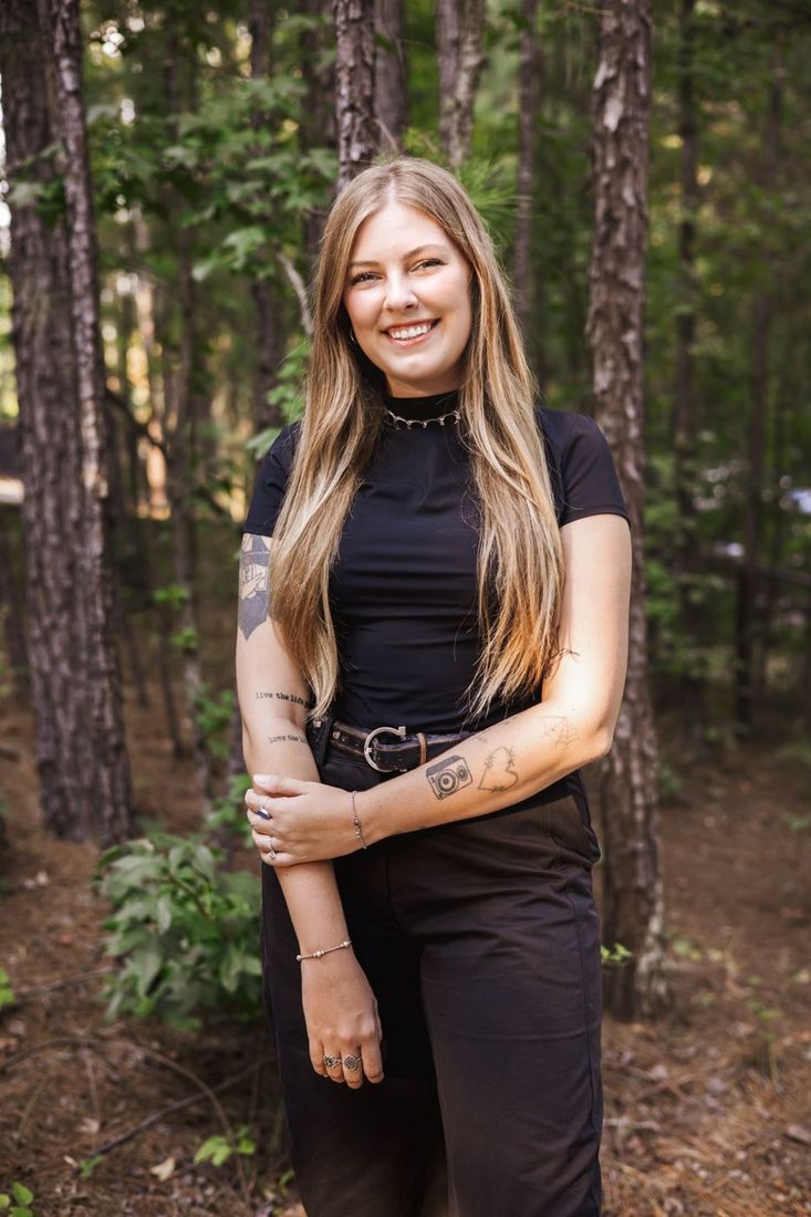 Tiffany Scheppler standing in a pine forest